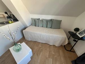 a small bedroom with a bed in a attic at Magnifique logement indépendant avec sa place de parking in La Celle-sous-Gouzon