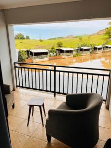 a balcony with a chair and a table and a view at The Duckpond Inn in Fraser