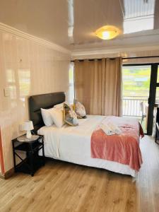 a bedroom with a large bed and a window at The Duckpond Inn in Fraser