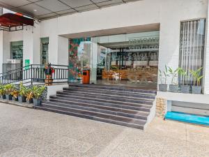 a store front with stairs in front of a building at Meotel Purwokerto in Purwokerto