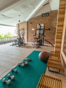 a gym with some rocks on the floor and benches at Meotel Purwokerto in Purwokerto