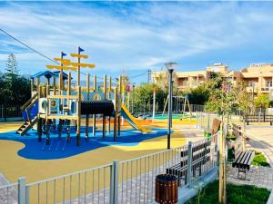 a playground with a slide in a park at Solon Apartments in Maleme