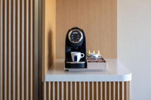 Un reloj encima de una mesa con pastelitos. en The Luce, St. Pete Beach, a Tribute Portfolio Hotel, en St Pete Beach