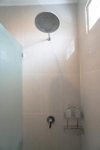 a bathroom with a shower with a shower head at Villa cassia in Kerobokan +25 photos
