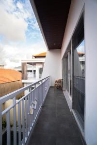 a balcony of a house with white walls at Villa cassia in Kerobokan