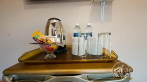 a tray with cups and bottles on top of a counter at uPhondo Lodge in Bulawayo