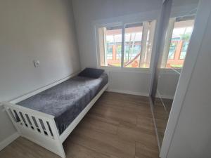 En eller flere senge i et værelse på Casa de temporada Capão da Canoa