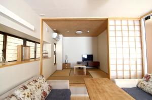 a living room with a couch and a table at Mcity in Wakasa in Naha