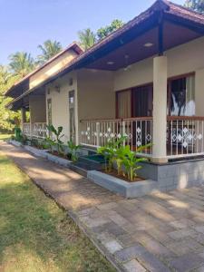 a house with plants in front of it at BharathaPuzha Resort in Kārakkād