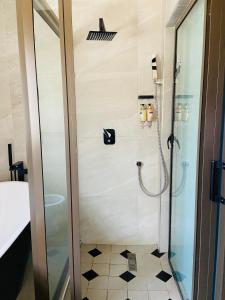een douche met een glazen deur in een badkamer bij Palm Leaf – Hazeldene Kwekwe with pool - 2333 in Kwekwe