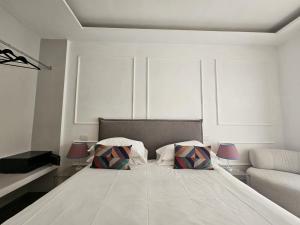 a bedroom with a large bed with two pillows at Be Your Home - Riviera Suites in Civitavecchia +28 photos