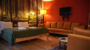 a living room with a bed and a couch at Treetops Park Hotel in Sile