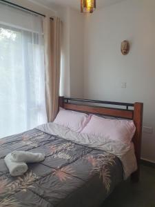 Ένα ή περισσότερα κρεβάτια σε δωμάτιο στο Tsavo Stanley kiambu Road