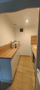 a small kitchen with a counter and a microwave at Le Derroja - Perpignan in Perpignan