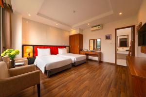 a hotel room with a bed and a living room at The Embassy Hotel Hanoi in Hanoi +69 photos