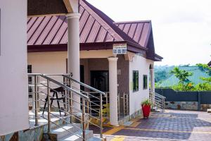 a building with a sign on the side of it at Aratina Apartments in Sunyani