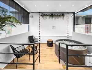 a balcony with a glass table and chairs at Hyde Park 6 Couples Retreat Apt With Jacuzzi in San Juan
