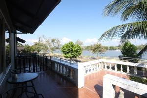 a balcony with a table and a view of the water at Funky Crab The River in Krabi