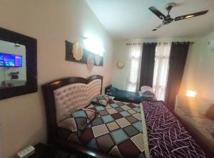 MohaliExclusive Floor on Manali Expressway for Family的一间卧室，里面有一张床和一个吊扇