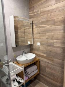 een badkamer met een wastafel en een spiegel bij Апартамент AZUR PREMIUM in Varna