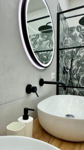a bathroom with a white sink and a mirror at Fiumicino House Stay in Fiumicino