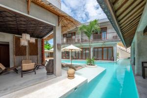a villa with a swimming pool and a house at Kano Uluwatu in Uluwatu