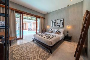a bedroom with a large bed and a pool at Kano Uluwatu in Uluwatu