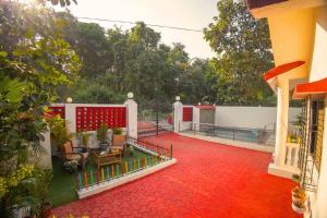 a house with a red floor and a red carpet at Mount Aurora I Staymist in Karjat