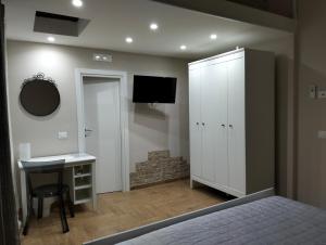 a bedroom with a bed and a desk and a mirror at Divingreta 1820 in Ottaviano