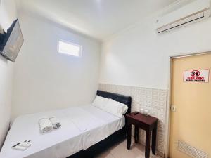 En eller flere senge i et værelse på CQA Living TANA 1 By ARBA