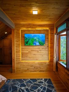 Zimmer mit einem TV in einem Blockhaus in der Unterkunft Bagas Luxury Glamping in Kejajar + 48 Fotos