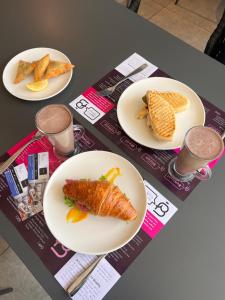 a table with three plates of food on it at Elite One Bedroom Apartment Westlands, Swimming pool, gym, workspace ,Wonderiss Properties close proximity to GTC, JW Mariott and Kempinski in Nairobi