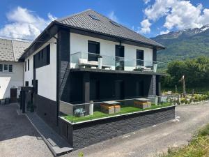a house with a balcony on the side of a road at Appartement T3 Terrasse in Frontenex-Villard-Rosset