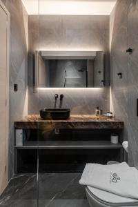 a bathroom with a sink and a toilet at ELA apartments in Volos