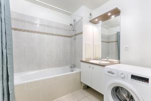 ein Badezimmer mit Waschbecken und Waschmaschine in der Unterkunft Venturia - 23 min en train de Paris in Le Plessis-Bouchard + 4 Fotos