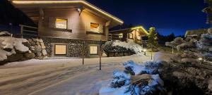a house covered in snow at night at Das Resort Brixen in Brixen im Thale