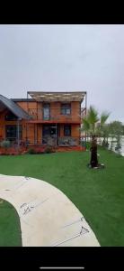 a person standing in front of a house at Wooden villas in Chrysoupolis