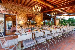 a dining room with white tables and chairs at VILLA PITTI AMERIGHI 26, Emma Villas in Pieve a Nievole