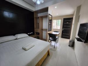 Кровать или кровати в номере Grand Apartelle Mandaue Cebu