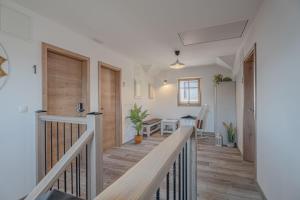a hallway of a home with a staircase and a room at Lukec Estate in Kostel +28 photos