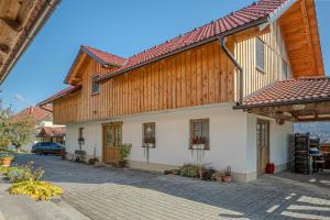 a large wooden house with a red roof at Lukec Estate in Kostel