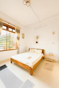 a bedroom with a large bed in a room at Sim House in Hue