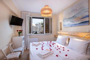 a bedroom with a bed with red roses on it at Villa Arancia Private Pool, 2 Jacuzzis & BBQ Area in Pigi