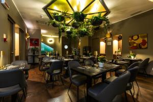 a restaurant with tables and chairs and a chandelier at Trevi Collection Hotel - Gruppo Trevi Hotels in Rome