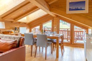 a dining room with a table and chairs at ORTA Chalet in Les Gets