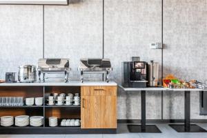 a kitchen with a counter with a coffee maker at Silk Road Tashkent in Tashkent