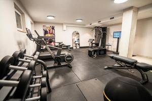a gym with several treadmills and machines at Hotel Deutsches Haus in Dinkelsbühl