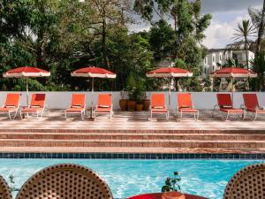 a group of chairs and umbrellas next to a pool at Céline & Lolo in Nairobi