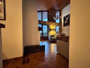 a living room with a couch and a table at Chalet des Cinq in Samoëns
