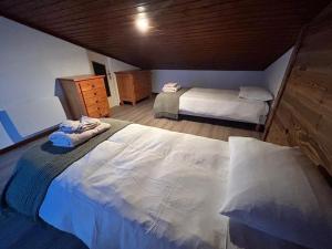 a bedroom with a large bed and two twin beds at Chalet des Cinq in Samoëns